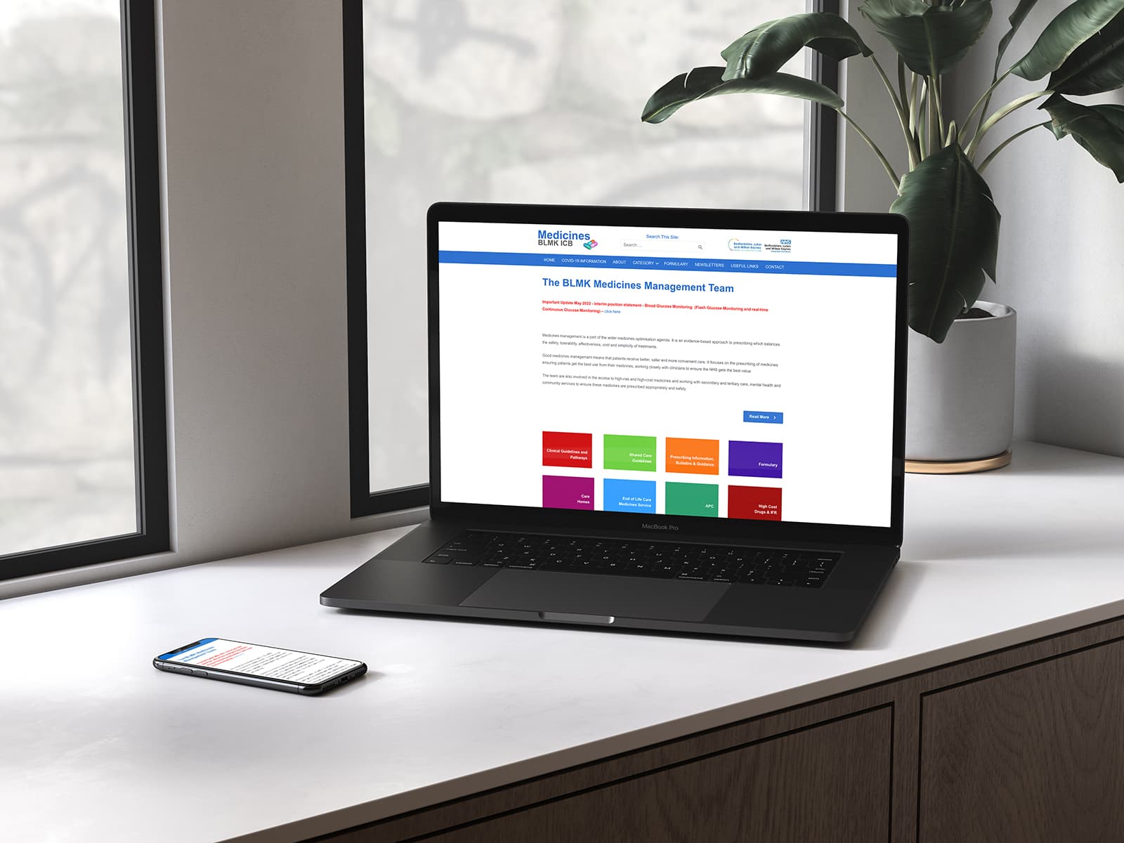 laptop on desk showing NHS website